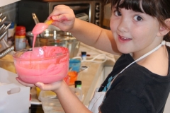 Naomi mixing colors for the cake.